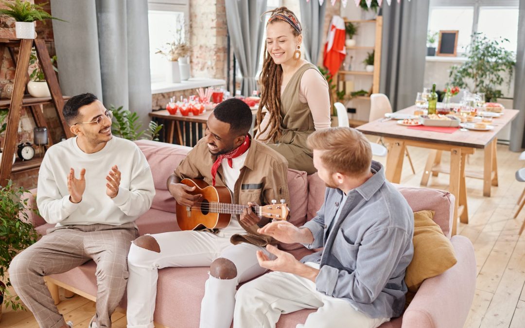 people clapping while the man playing guitar